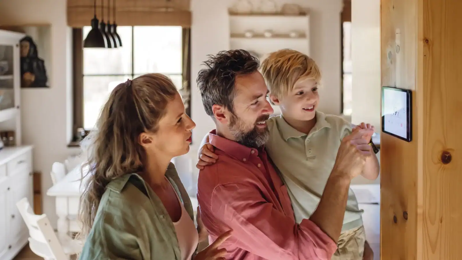 Family checking smart thermostat for HVAC system.