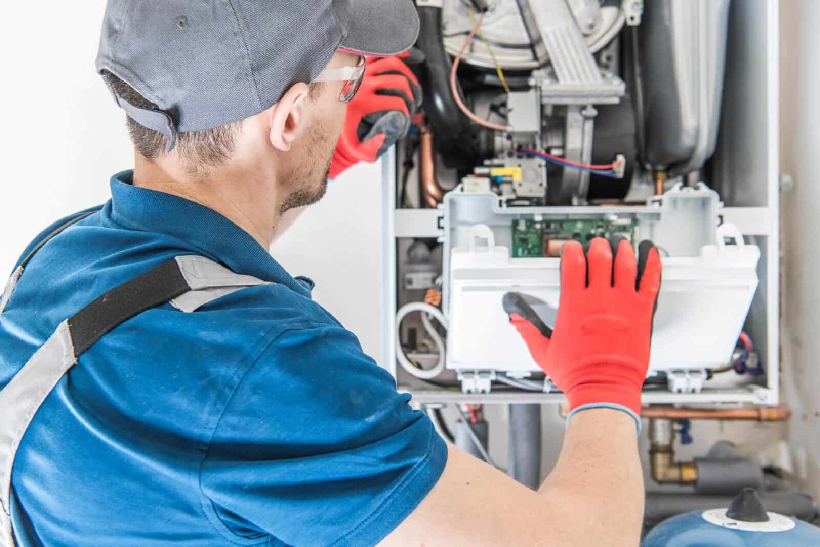 High-efficiency HVAC technician repairing heating system, energy solutions, McDougall Energy services.