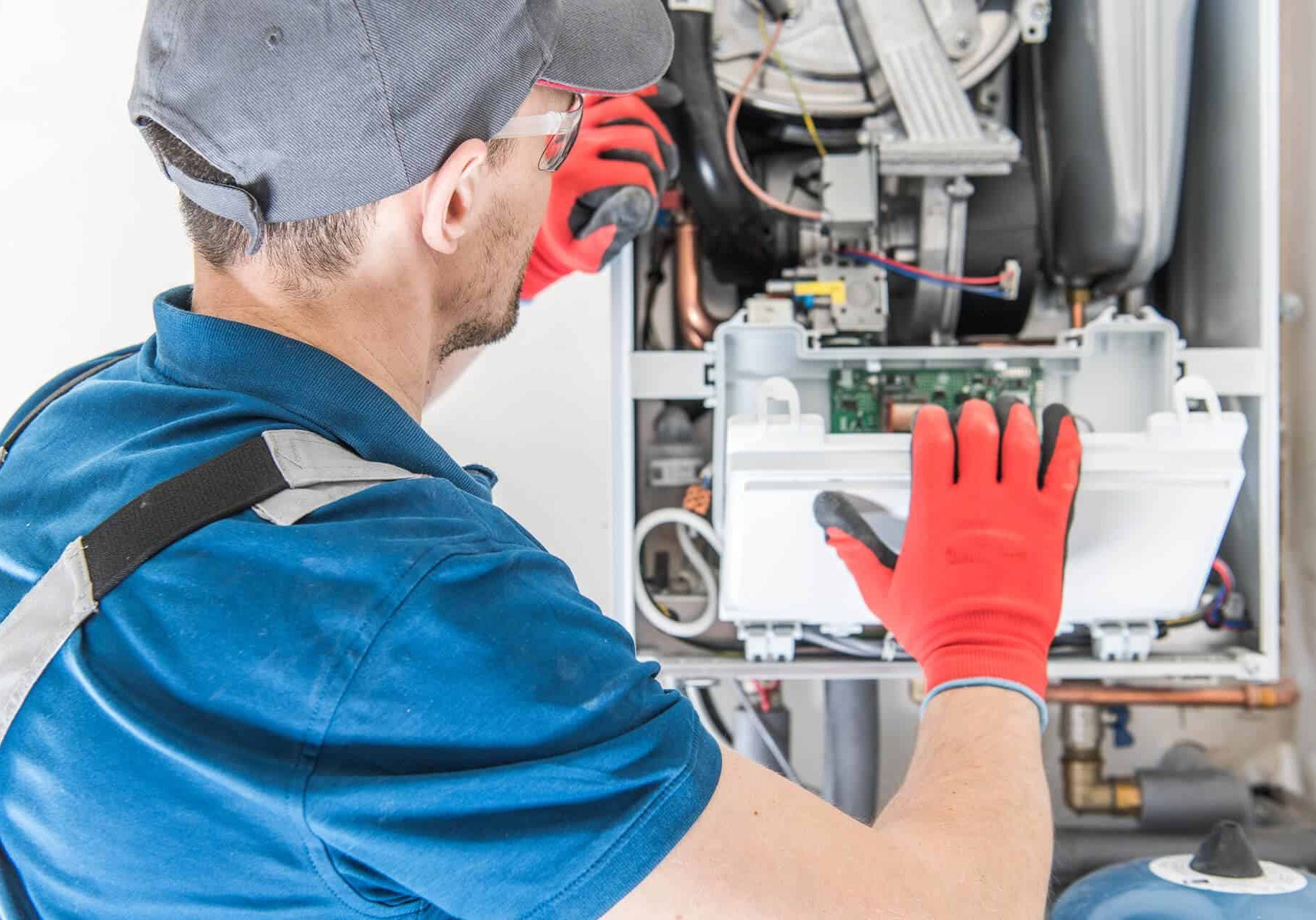 High-efficiency HVAC technician repairing heating system, energy solutions, McDougall Energy services.